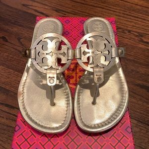 Tory Burch gold sandals in vegan leather